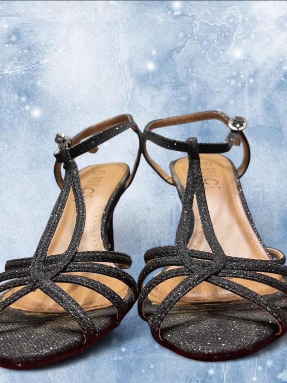 Black glittery heels with adjustable ankle strap.